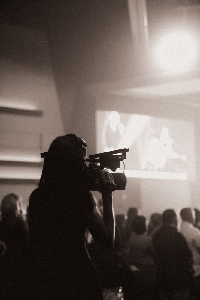 Silhouette of Bethany filming at Mission Church