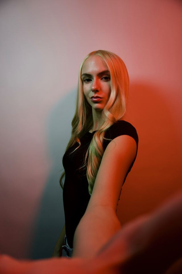 Bethany looking over her shoulder under red studio light