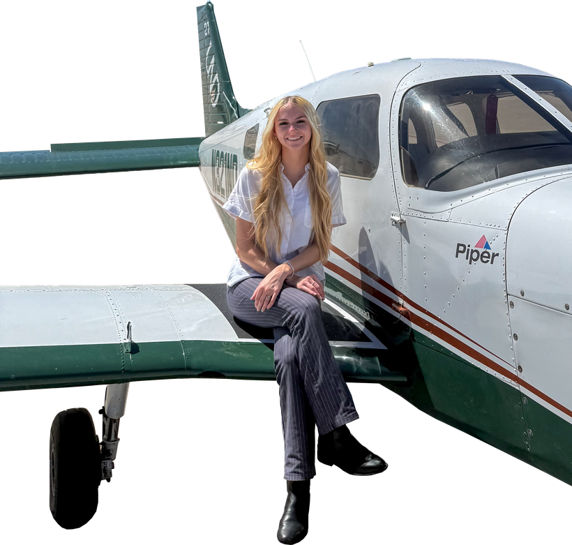 Bethany sitting on the wing of a Piper Archer TX